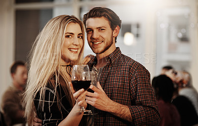 Buy stock photo Cropped portrait of an affectionate young couple enjoying a glass of wine
