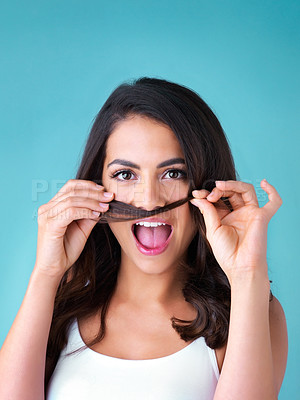 Buy stock photo Woman, portrait and quirky hair mustache in studio, funny and silly comic or comedy on blue background. Female person, smile and goofy hairstyle for humor, play games and haircare joke for confidence