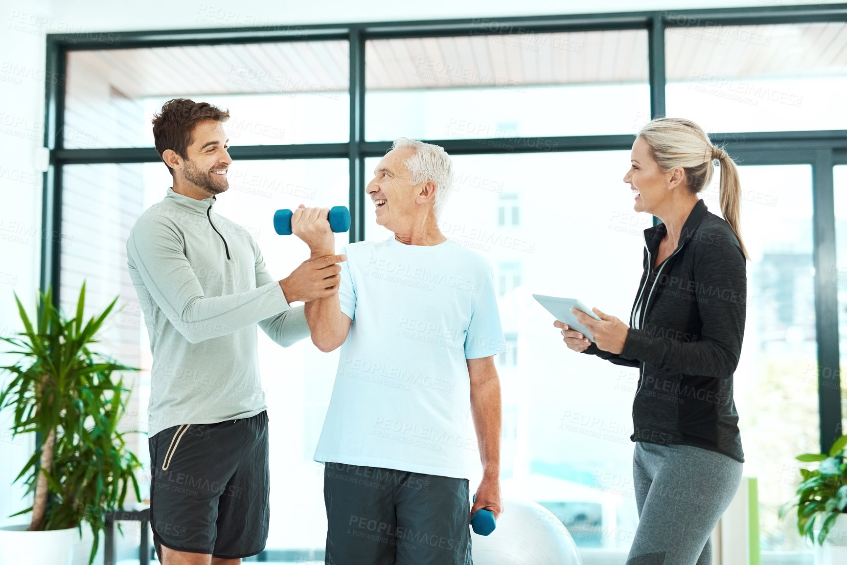 Buy stock photo Shot of physiotherapists working with a senior therapist