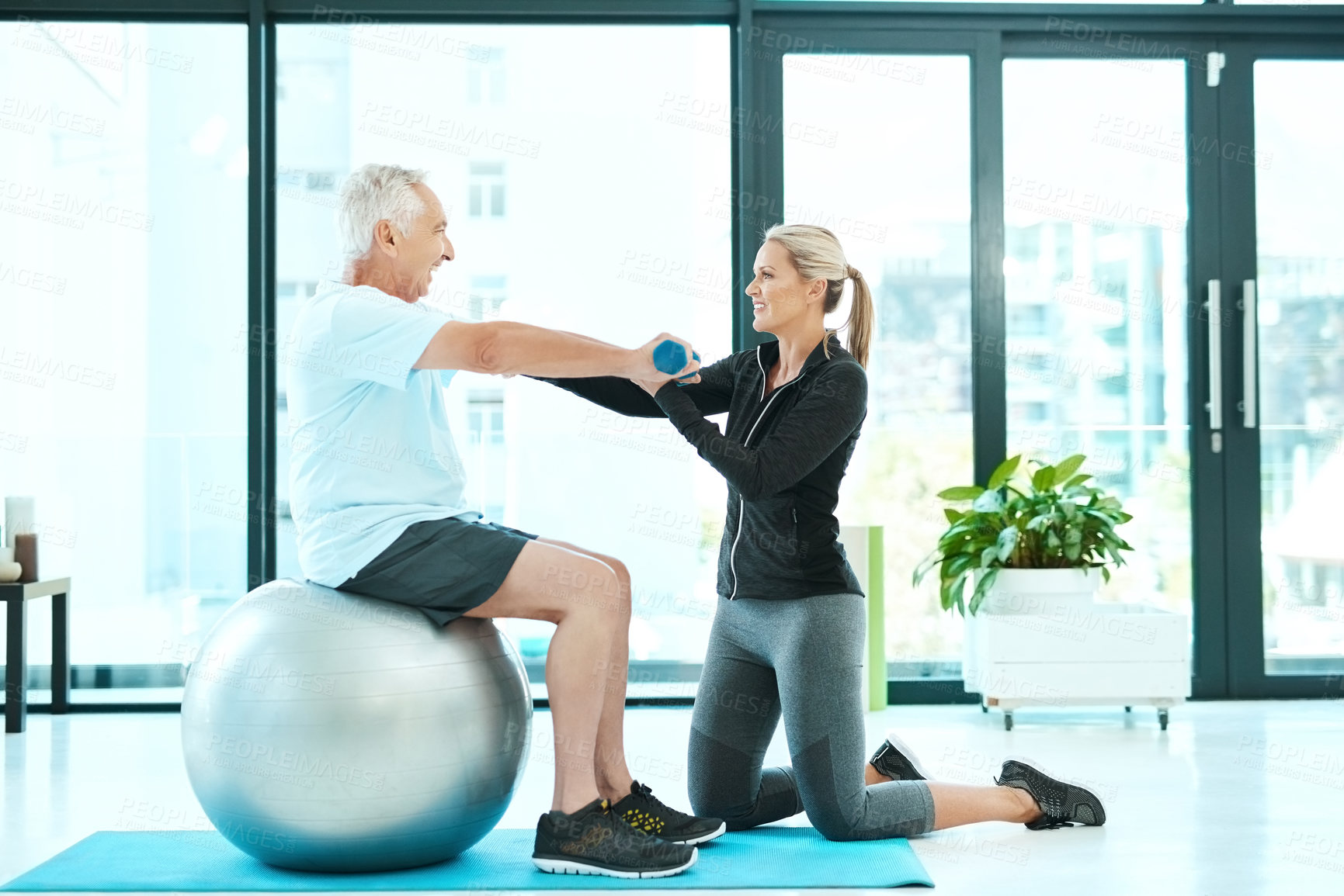 Buy stock photo Elderly man, woman and physiotherapy in exercise or healing in senior care, retirement and fitness center for health. Physiotherapist, patient and workout with yoga ball, rehabilitation and recovery