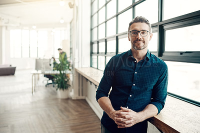 Buy stock photo Portrait of a confident mature businessman working in a modern office