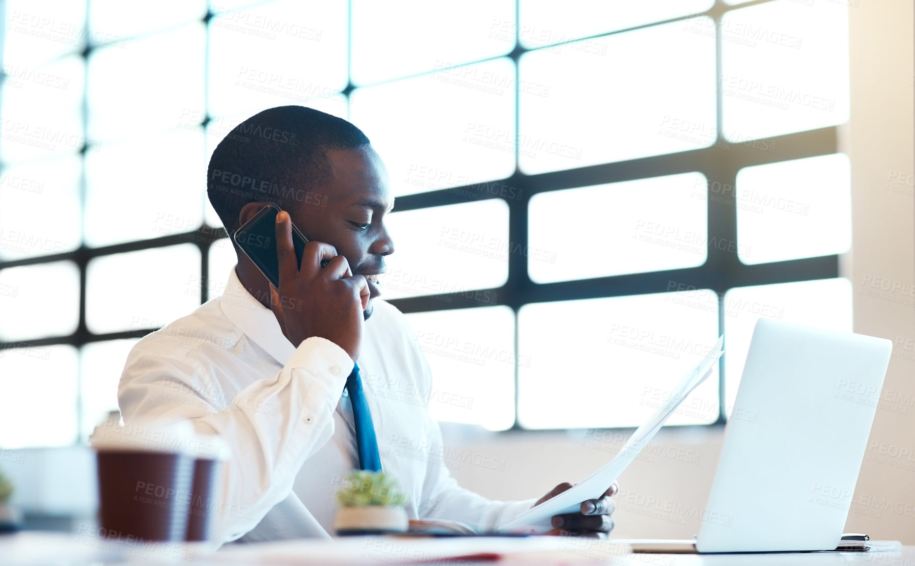 Buy stock photo Phone call, business and black man with laptop, paperwork and conversation to check schedule. African person, employee and consultant with documents, pc and consulting with accounting firm or finance