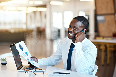 Buy stock photo Portrait of a cheerful young businessman talking on his cellphone and making notes while being seated at his desk in the office during the day