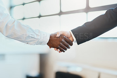 Buy stock photo Closeup of two unrecognizable businesspeople shaking hands in agreement inside of the office at work