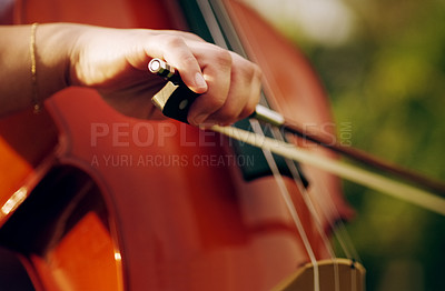 Buy stock photo Cropped shot of an unrecognizable woman playing a cello in the backyard