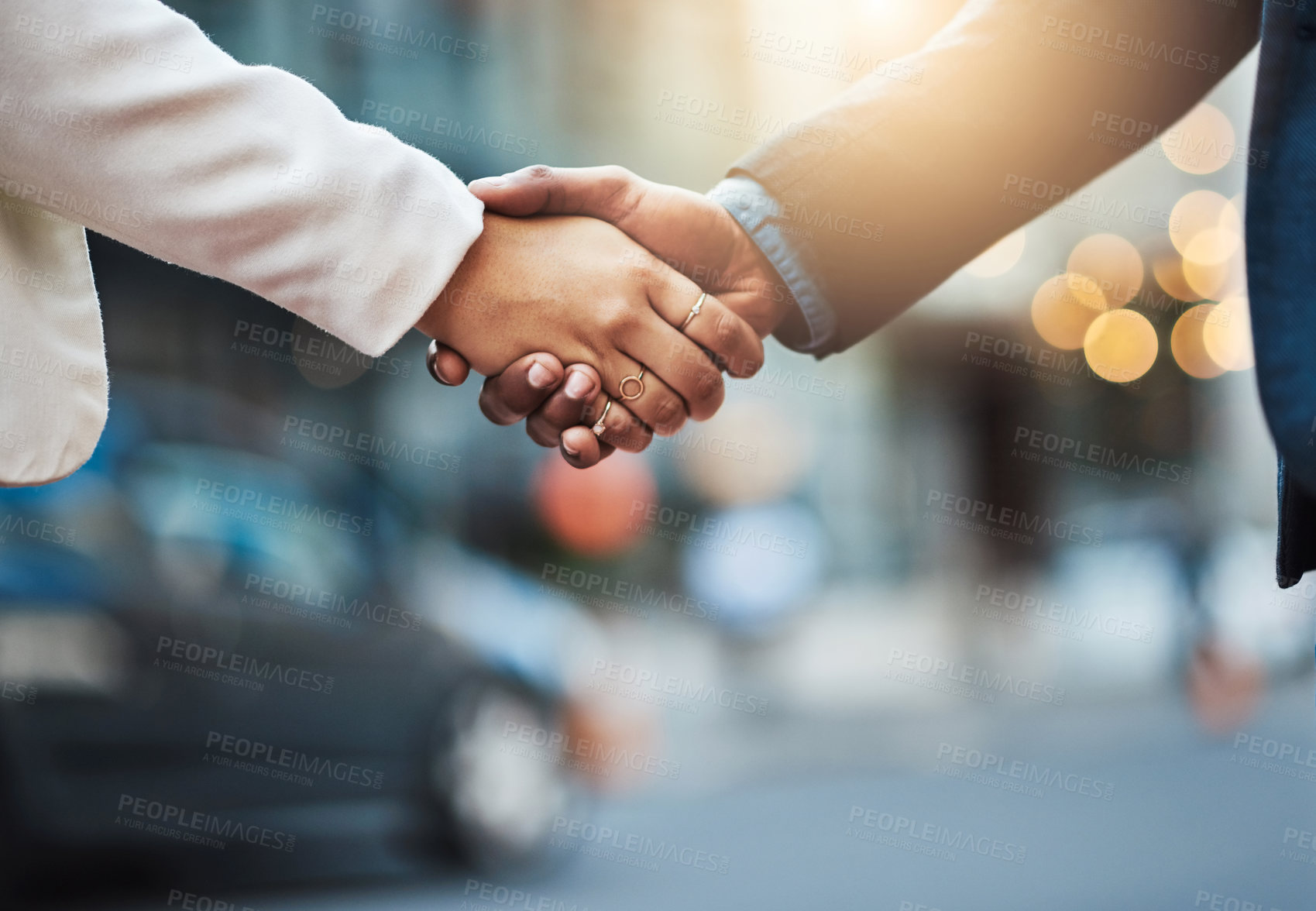 Buy stock photo Closeup shot of two unrecognizable businesspeople shaking hands in the city