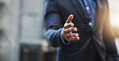 Buy stock photo Closeup shot of an unrecognizable businessman extending a handshake in the  city