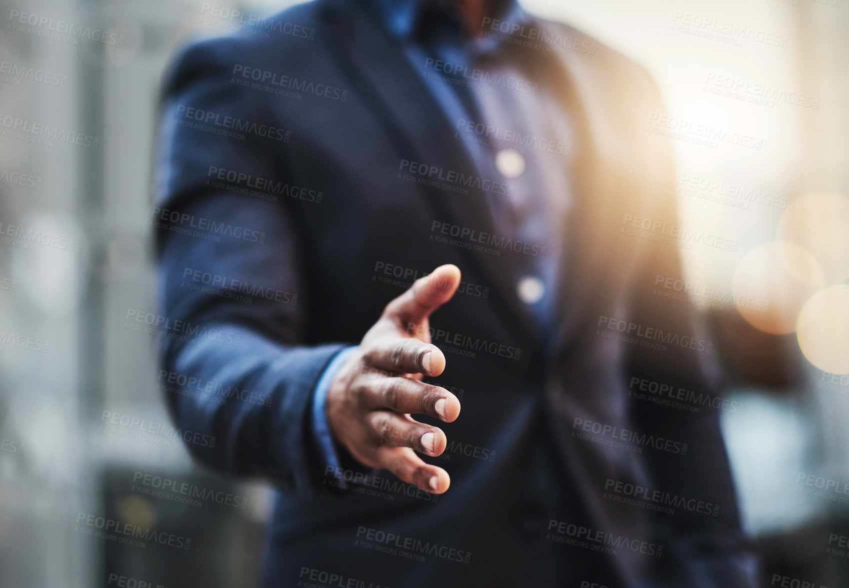 Buy stock photo Closeup shot of an unrecognizable businessman extending a handshake in the  city