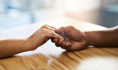 Buy stock photo Cropped shot of an unidentifiable man and woman holding hands on a table
