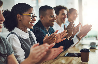 Buy stock photo Cropped shot of a group of young businesspeople applauding while sitting in the conference room during a seminar