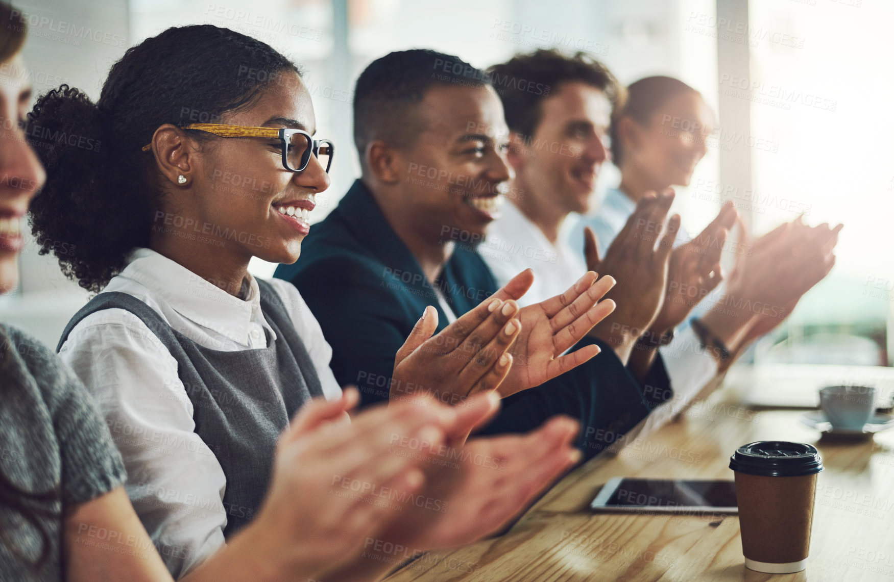 Buy stock photo Cropped shot of a group of young businesspeople applauding while sitting in the conference room during a seminar