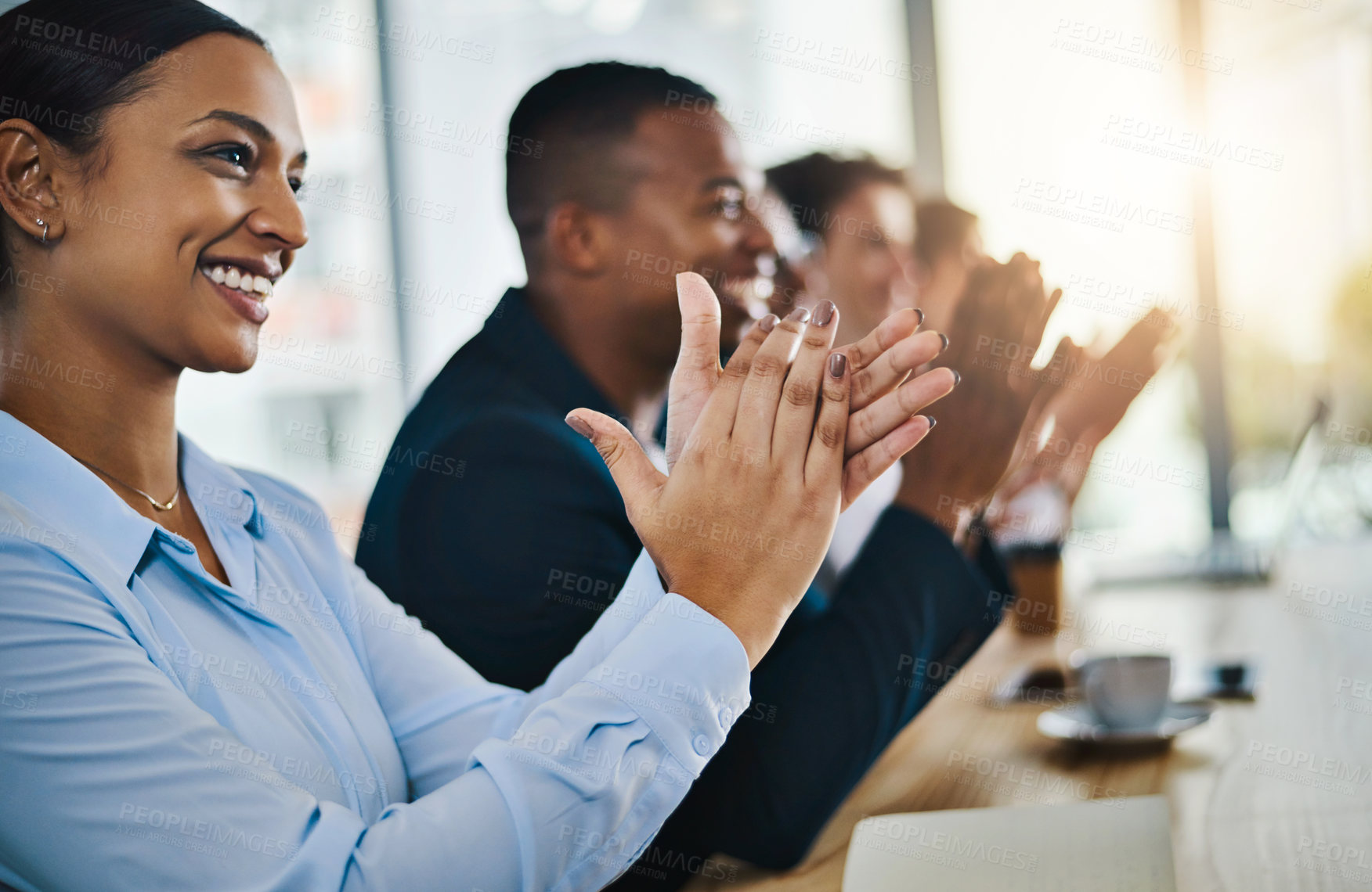 Buy stock photo Cropped shot of a group of young businesspeople applauding while sitting in the conference room during a seminar