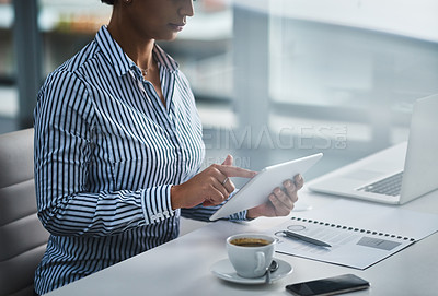 Buy stock photo Closeup shot of an unrecognizable businesswoman working on a digital tablet in an office