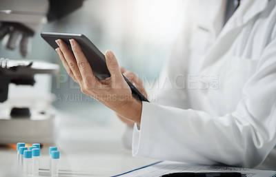 Buy stock photo Cropped shot of an unrecognizable mature female scientist using a tablet while doing research in her lab