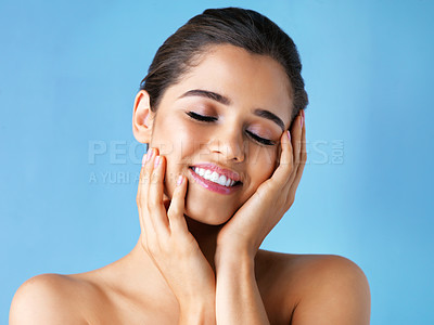 Buy stock photo Happy woman, skincare and hands in studio for wellness, beauty and make up on blue background. Dermatology, eyes closed and female person with smile for skin glow, luxury and spa or salon treatment