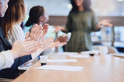 Buy stock photo Low angle shot of a group of businesspeople applauding a colleague while sitting in the boardroom during a meeting