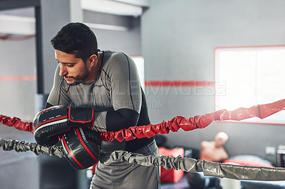 Buy stock photo Cropped shot of a professional fighter training in the gym