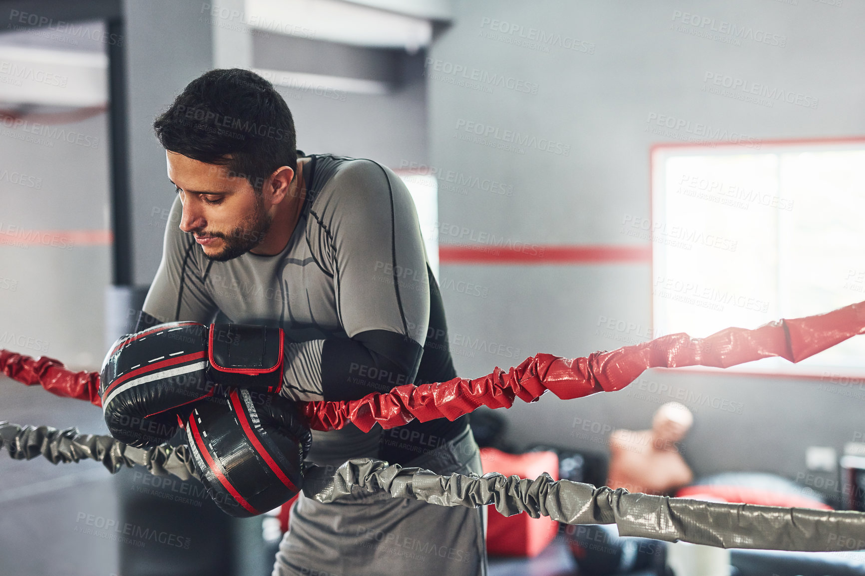 Buy stock photo Cropped shot of a professional fighter training in the gym