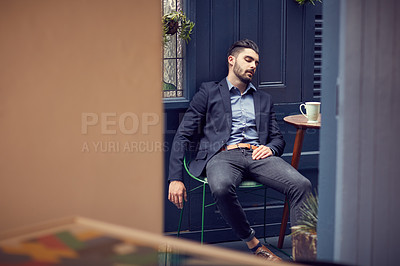 Buy stock photo Cropped shot of a young handsome businessman exhausted, resting at a cafe
