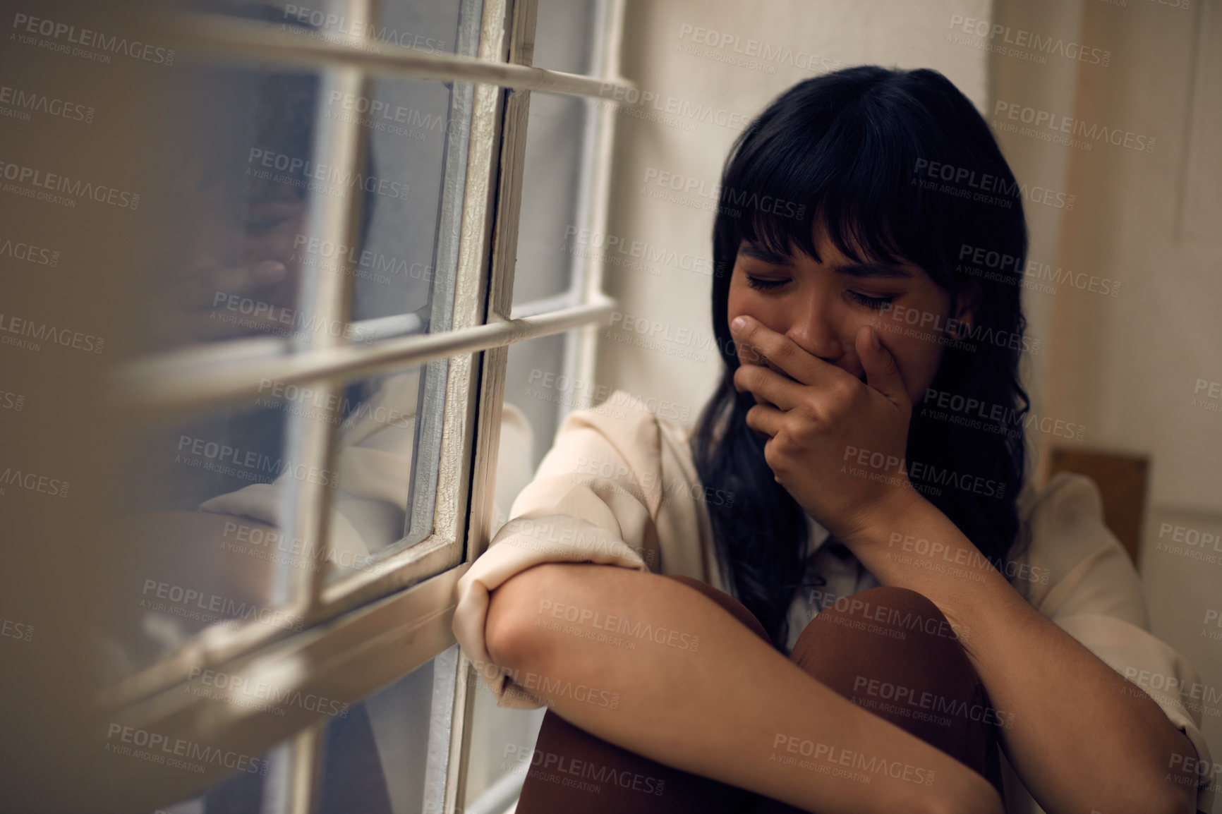 Buy stock photo Cropped shot of a young attractive woman feeling depressed at home