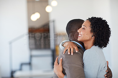 Buy stock photo Cropped shot of a young couple embracing each other in the office