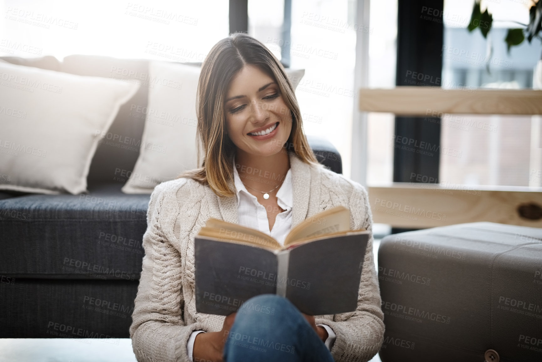 Buy stock photo Woman, home and smile with reading book to relax on day off and leisure. Female person, holiday and happy in living room with novel for story, information or knowledge on break, chill and self care