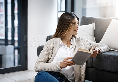 Buy stock photo Thinking, home and woman reading book, relax and peace with ideas and hobby in lounge. Person, apartment and girl on the ground, novel and literature with decision and choice with creativity and calm