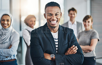 Buy stock photo Portrait of confident young business people standing with their arms folded inside of the office at work during the day