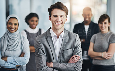 Buy stock photo Portrait of confident young business people standing with their arms folded inside of the office at work during the day