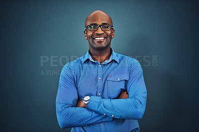 Buy stock photo Business, black man and portrait with arms crossed in a studio feeling proud from auditor work. Blue background, smile and African employee with success and leadership vision with glasses and idea