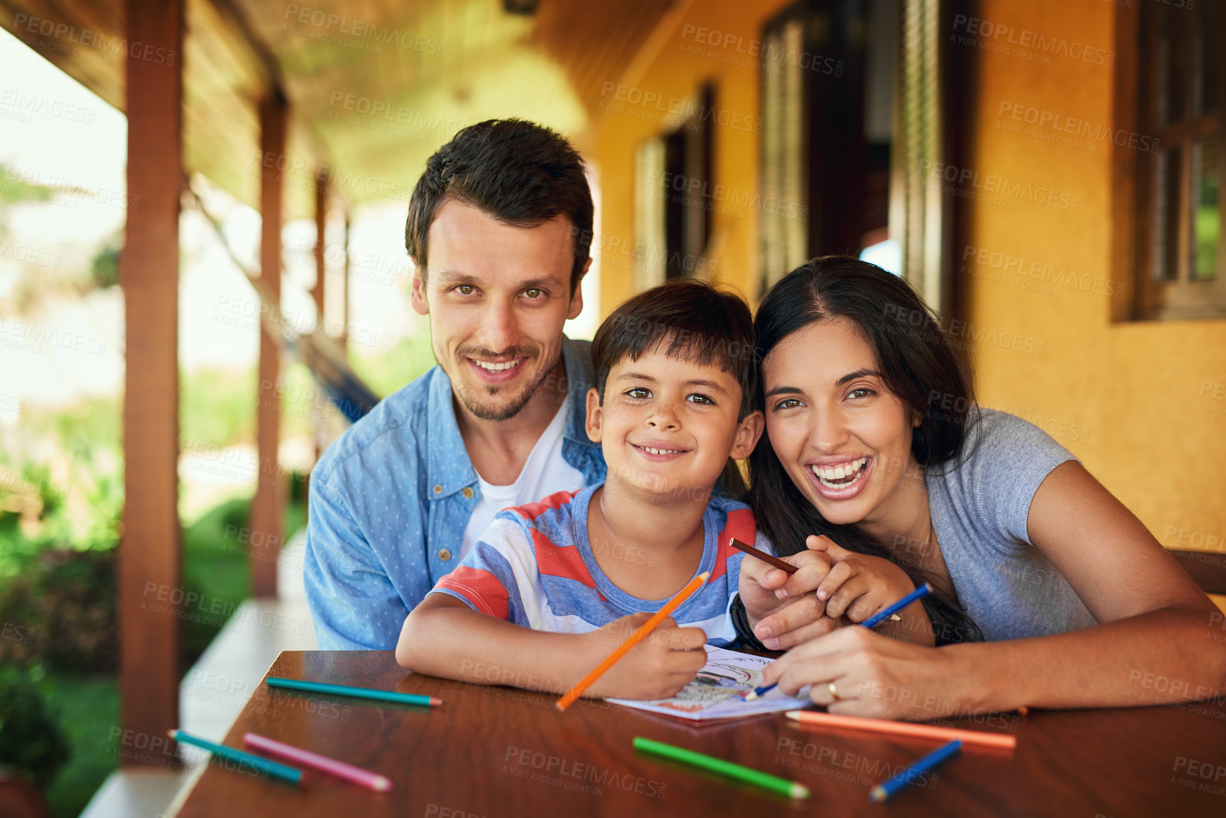 Buy stock photo Portrait of a couple and their son coloring in together outdoors