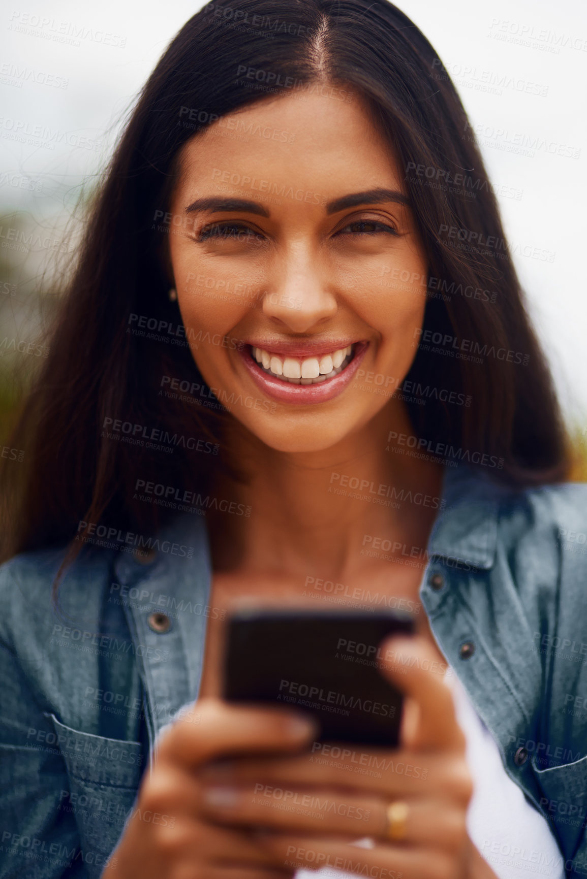 Buy stock photo Portrait of an attractive young woman using a mobile phone in a park