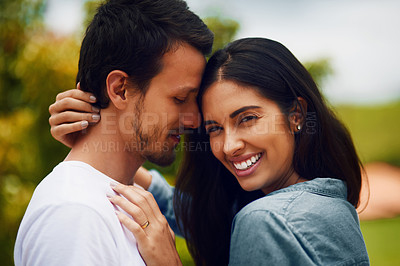 Buy stock photo Shot of an affectionate young couple spending a romantic day in the park