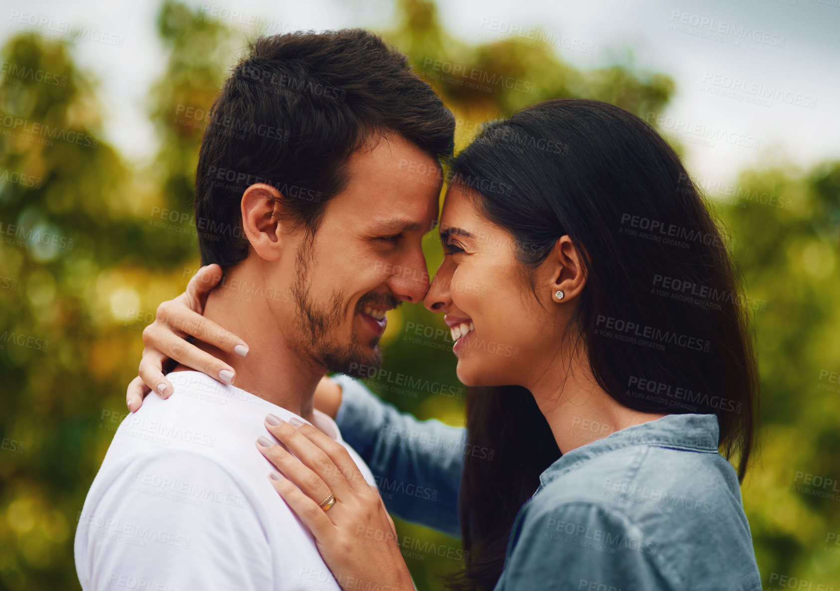 Buy stock photo Love, hug and bonding with couple in park for romance, smile and summer vacation. Happiness, commitment and care with man and woman relax on date in nature for marriage, support and partnership