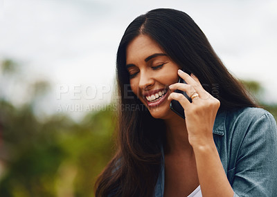 Buy stock photo Shot of an attractive young woman using a mobile phone in a park