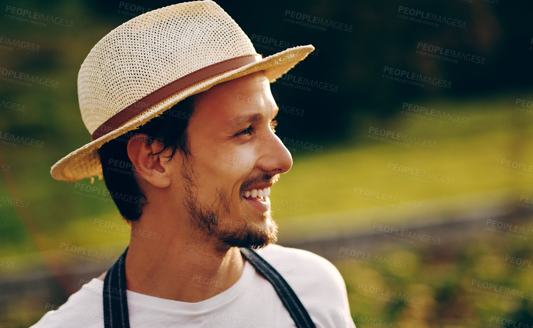 Buy stock photo Shot of a handsome young man working in a garden