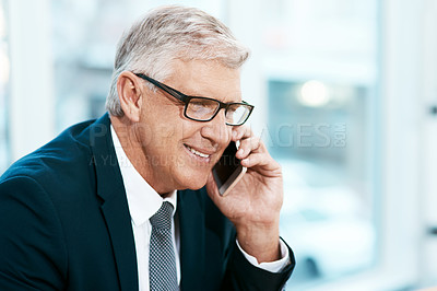 Buy stock photo Cropped shot of a handsome mature businessman making a phonecall while working in the office