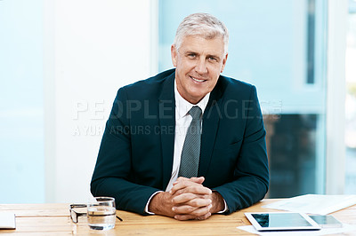 Buy stock photo Cropped portrait of a handsome mature businessman sitting at his desk in the office