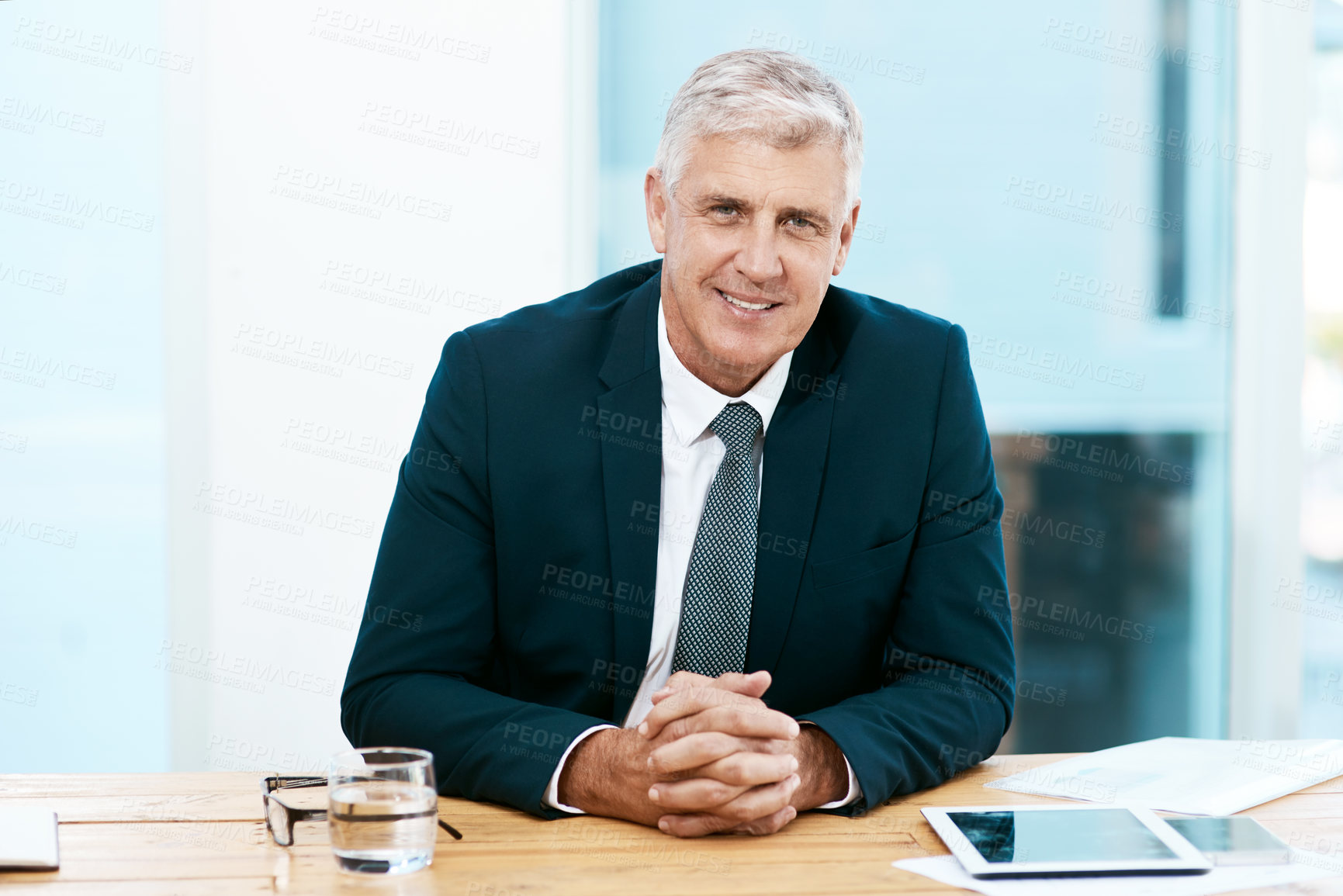 Buy stock photo Cropped portrait of a handsome mature businessman sitting at his desk in the office
