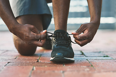Buy stock photo Feet, sport and shoes tie on pavement with person and athlete for running and jog. Shoelace, wellness, fitness with cardio, workout and race training on concrete for marathon outdoor for health