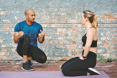 Buy stock photo Conversation, talking and coach with woman for workout, exercise and fitness for sport. Partnership, personal trainer and athlete on break by brick wall at gym for wellness, training and health
