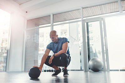 Buy stock photo Workout, black man and fitness ball in gym for strength, training and wellness for healthy lifestyle. Sports, male person and exercise for healthcare, resilience and bodybuilder with commitment
