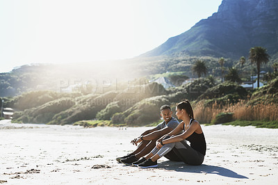 Buy stock photo Happy, sand and couple in nature to relax for bonding, relationship and love outdoors. Beach, dating and man and woman talking on break after exercise, workout and training together on weekend