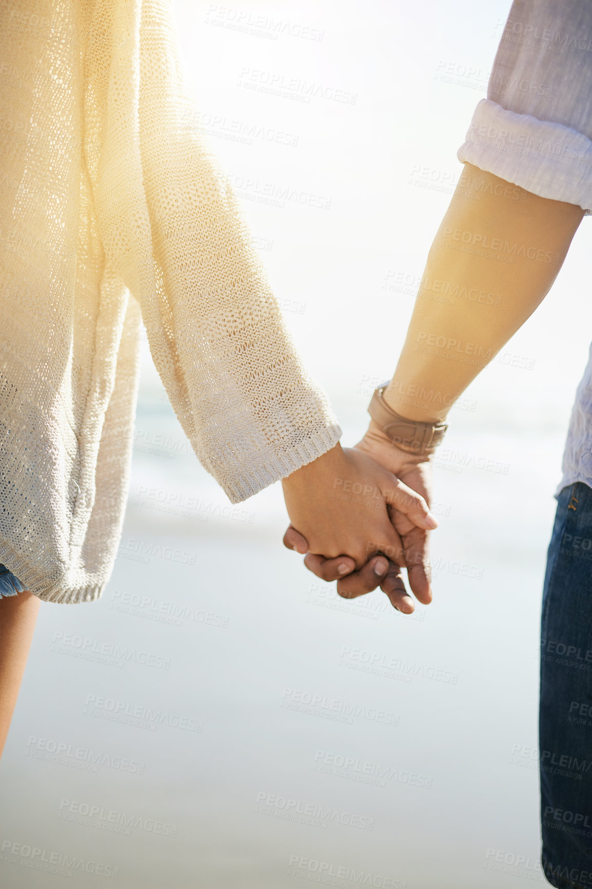 Buy stock photo Couple, back and holding hands on beach for travel, bonding and holiday with sunshine, love and support. Man, woman and together outdoor by ocean for vacation, relax and summer with romantic date