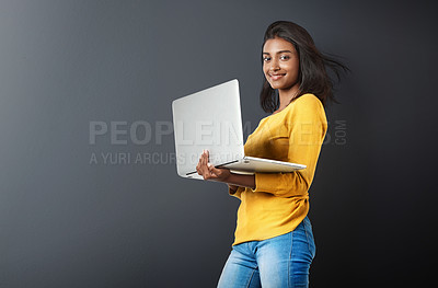 Buy stock photo Laptop, portrait and woman typing online, internet or web email isolated in a studio grey background feeling happy. Mockup, social media and female student or person working and using technology