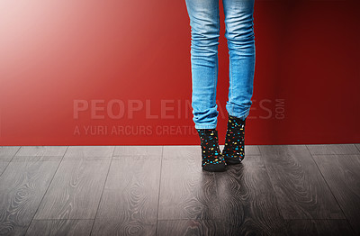 Buy stock photo Fashion, jeans and legs of woman in studio with stylish clothes standing on red background. Trendy, edgy and fashionista in modern outfit, cool style or denim for crazy socks day on floor or ground