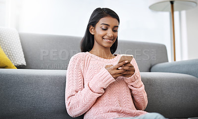Buy stock photo Relax, floor and Indian woman in living room with phone for social media, networking or streaming. Happy, scroll and girl in lounge on smartphone for communication, online chat or post search in home
