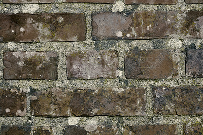 Buy stock photo Closeup of an old, faded, dirty brick wall with copyspace. Damaged rough brick wall surface. Old brown bricks with dirt and copyspace. Zoom on in detail and pattern of brick, different size and shape