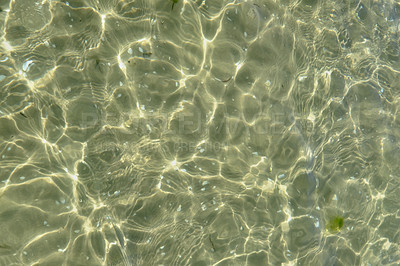 Buy stock photo Above view of sunlight reflecting on water at beach. Closeup of shallow waves and calm ripples on coastline on sunny day outside. Clear liquid refracting sun rays in summer for copy space background
