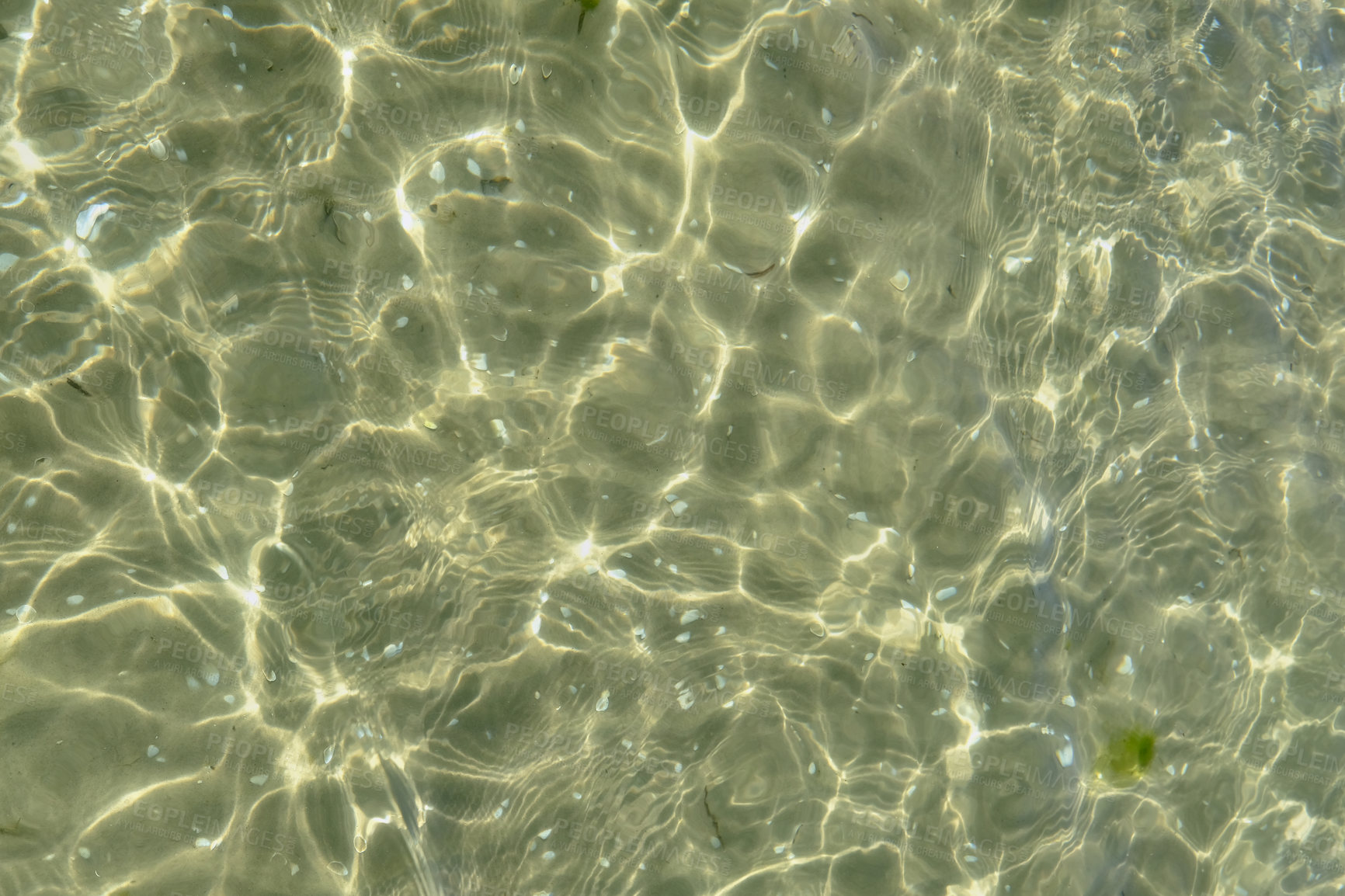 Buy stock photo Above view of sunlight reflecting on water at beach. Closeup of shallow waves and calm ripples on coastline on sunny day outside. Clear liquid refracting sun rays in summer for copy space background